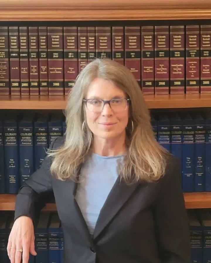 Attorney Shannon Soignier in her office with law library
