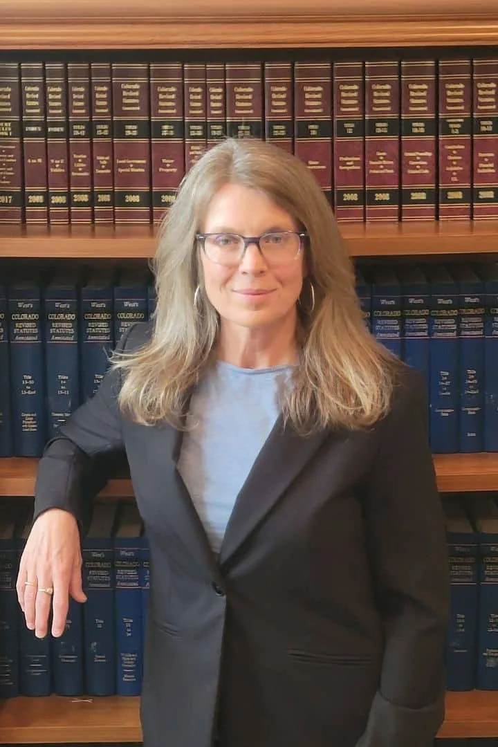 Attorney Shannon Soignier in her office with law library